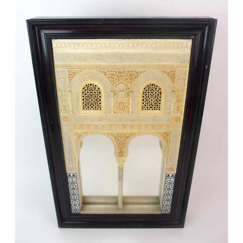 92 - A painted plaster and alabaster Alhambra wall mirror