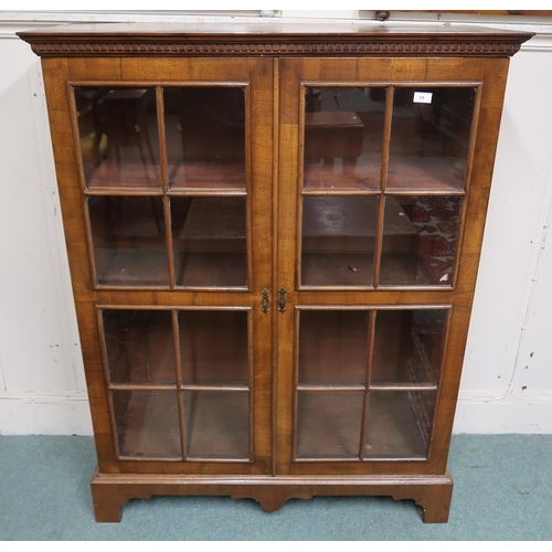 11 - An early 20th century mahogany glazed two door bookcase, 138cm high x 107cm wide x 37cm deep