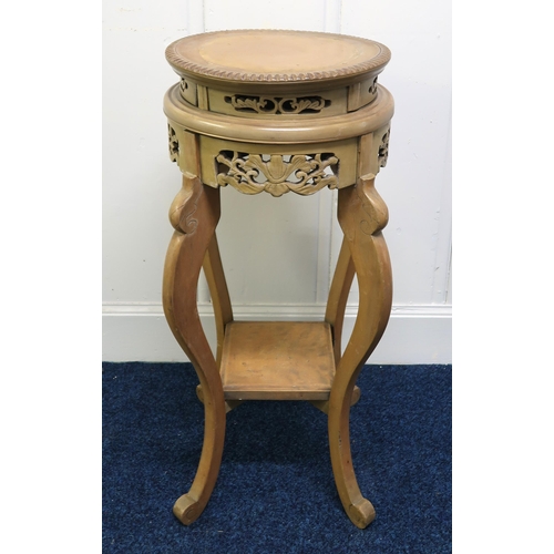 20 - A 20th century Oriental hardwood two tier jardinière stand with carved fretwork friezes, 76cm high