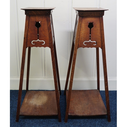24 - A pair of late Victorian Liberty style Arts & Crafts plant stands, 87cm high (2)