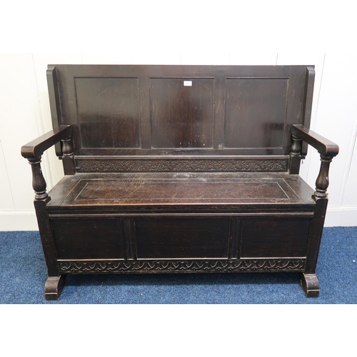57 - A 20th century stained oak monks bench, 99cm high x 131cm wide x 49cm deep