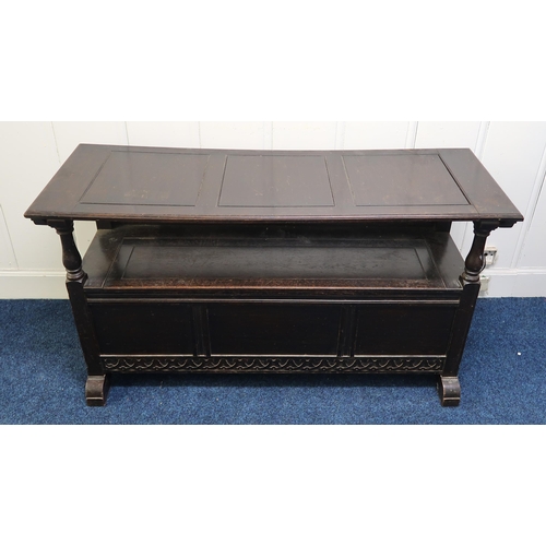 57 - A 20th century stained oak monks bench, 99cm high x 131cm wide x 49cm deep