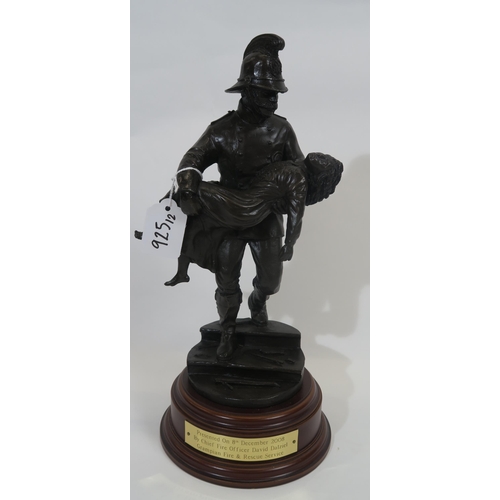 925 - A bronzed composite figure of a Fireman carrying a young girl, with brass presentation plaque inscri... 