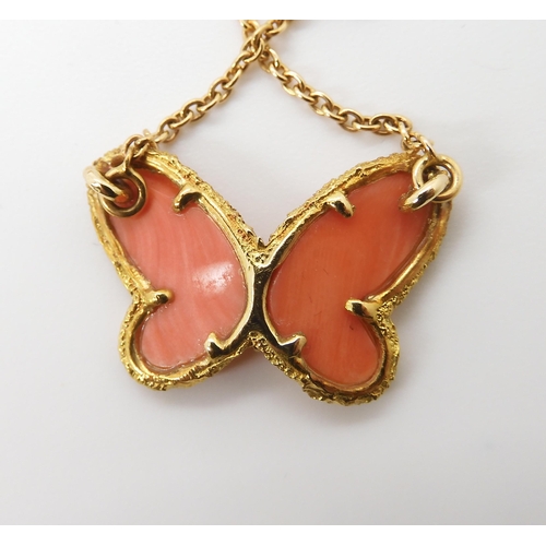 654 - A VAN CLEEF & ARPELS CORAL BUTTERFLY NECKLETthe body set with a diamond, the wings set with cora... 