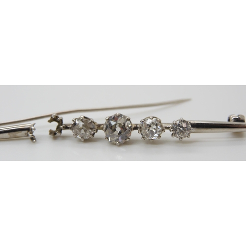 657 - FOUR OLD CUT DIAMONDSset in a broken white metal brooch. the four diamonds are estimated approx, lar... 