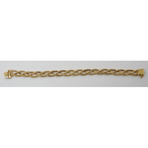 659 - AN 18CT GOLD ITALIAN MADE PLAITED BRACELETmade from three strands of herringbone chain, with Italian... 