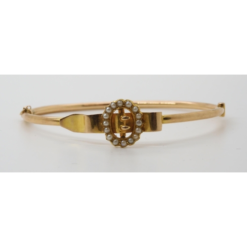 660 - A 15CT GOLD BUCKLE BANGLEthe buckle set with split pearls. Inner diameter approx 5.5cm x 4.8cm, weig... 