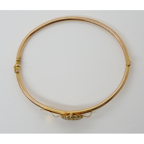 660 - A 15CT GOLD BUCKLE BANGLEthe buckle set with split pearls. Inner diameter approx 5.5cm x 4.8cm, weig... 