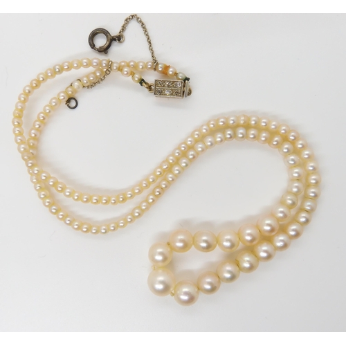 664 - A STRING OF GOOD QUALITY PEARLSwith a yellow and white metal diamond clasp, the largest pearl is 7mm... 