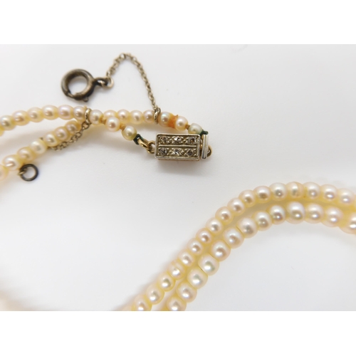 664 - A STRING OF GOOD QUALITY PEARLSwith a yellow and white metal diamond clasp, the largest pearl is 7mm... 