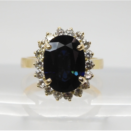 665 - A SAPPHIRE AND DIAMOND CLUSTER RINGmounted in 18ct gold, the sapphire is approx 12.5mm x 9.1mm x 4.4... 