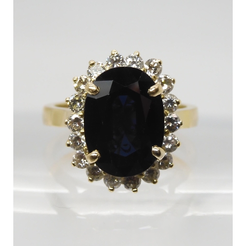 665 - A SAPPHIRE AND DIAMOND CLUSTER RINGmounted in 18ct gold, the sapphire is approx 12.5mm x 9.1mm x 4.4... 