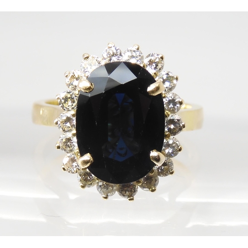 665 - A SAPPHIRE AND DIAMOND CLUSTER RINGmounted in 18ct gold, the sapphire is approx 12.5mm x 9.1mm x 4.4... 