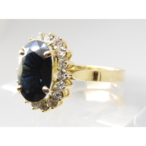 665 - A SAPPHIRE AND DIAMOND CLUSTER RINGmounted in 18ct gold, the sapphire is approx 12.5mm x 9.1mm x 4.4... 