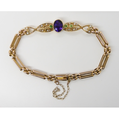 678 - A 15CT GOLD EDWARDIAN BRACELETin the suffragette colours. Set with demantoid garnet, (green,) pearls... 