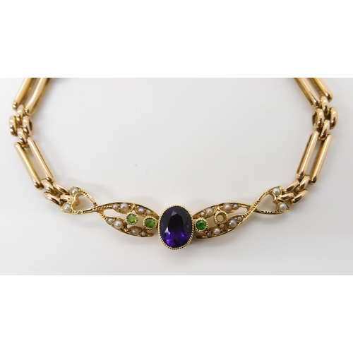 678 - A 15CT GOLD EDWARDIAN BRACELETin the suffragette colours. Set with demantoid garnet, (green,) pearls... 