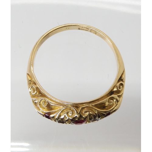 680 - AN 18CT GOLD RUBY AND DIAMOND RINGin a traditional scroll mount, finger size L, weight 4.5gms... 