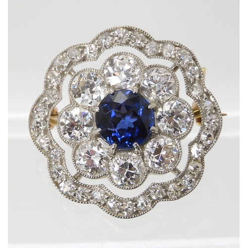 682 - A SAPPHIRE AND DIAMOND BROOCHset with a mid blue sapphire approx diameter 6.1mm, surrounded with 0.1... 