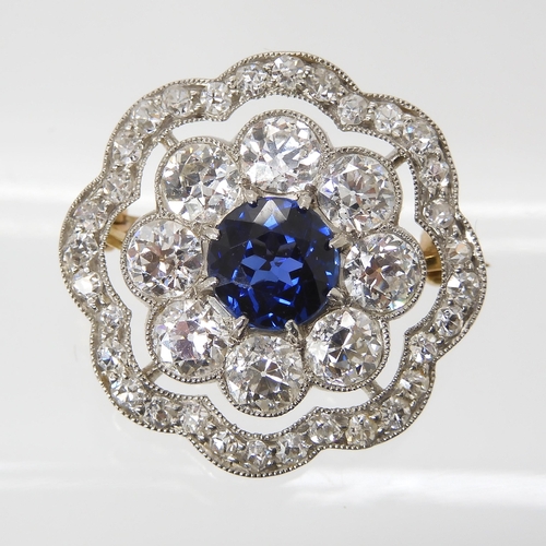 682 - A SAPPHIRE AND DIAMOND BROOCHset with a mid blue sapphire approx diameter 6.1mm, surrounded with 0.1... 