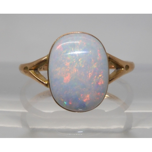 688 - A 9CT GOLD OPAL RINGset with a lively white opal of approx 12.2mm x 9.3mm. Finger size P1/2, weight ... 