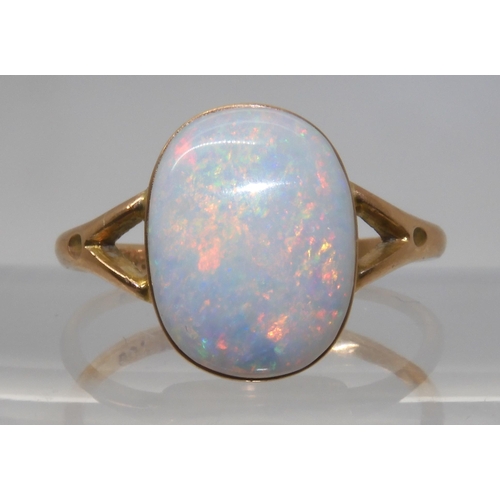 688 - A 9CT GOLD OPAL RINGset with a lively white opal of approx 12.2mm x 9.3mm. Finger size P1/2, weight ... 