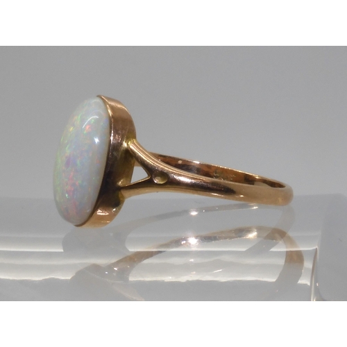 688 - A 9CT GOLD OPAL RINGset with a lively white opal of approx 12.2mm x 9.3mm. Finger size P1/2, weight ... 