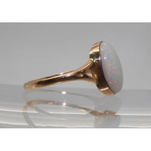 688 - A 9CT GOLD OPAL RINGset with a lively white opal of approx 12.2mm x 9.3mm. Finger size P1/2, weight ... 