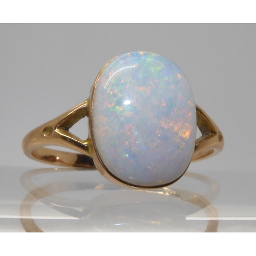 688 - A 9CT GOLD OPAL RINGset with a lively white opal of approx 12.2mm x 9.3mm. Finger size P1/2, weight ... 