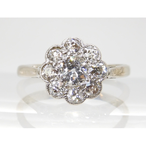 690 - AN OLD CUT DIAMOND FLOWER RINGmounted throughout in 18ct white gold and platinum, the central diamon... 