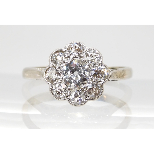 690 - AN OLD CUT DIAMOND FLOWER RINGmounted throughout in 18ct white gold and platinum, the central diamon... 