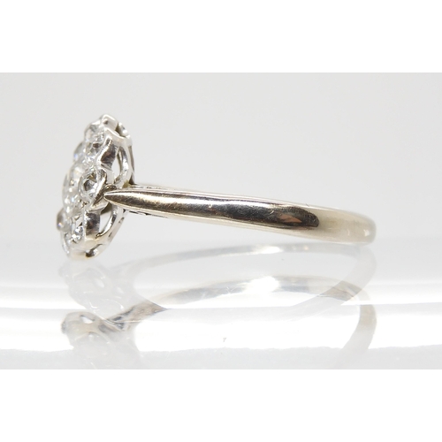 690 - AN OLD CUT DIAMOND FLOWER RINGmounted throughout in 18ct white gold and platinum, the central diamon... 