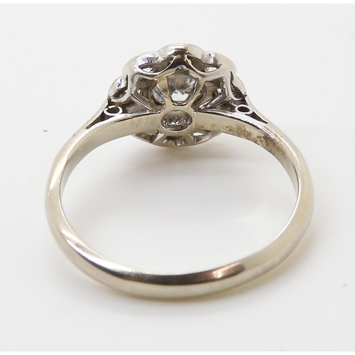 690 - AN OLD CUT DIAMOND FLOWER RINGmounted throughout in 18ct white gold and platinum, the central diamon... 