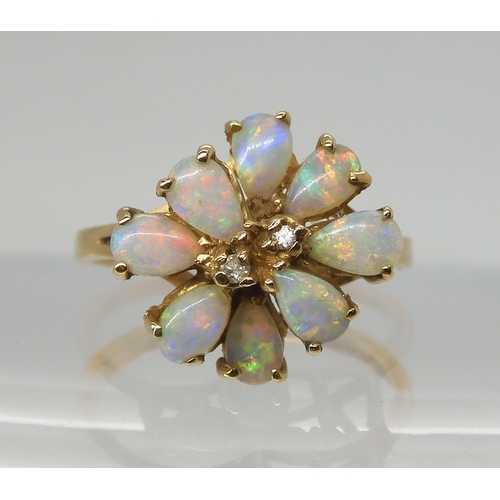 693 - A RETRO 14K GOLD OPAL CLUSTER RINGset with two diamond accents to the centre, span approx 13.4mm x 1... 