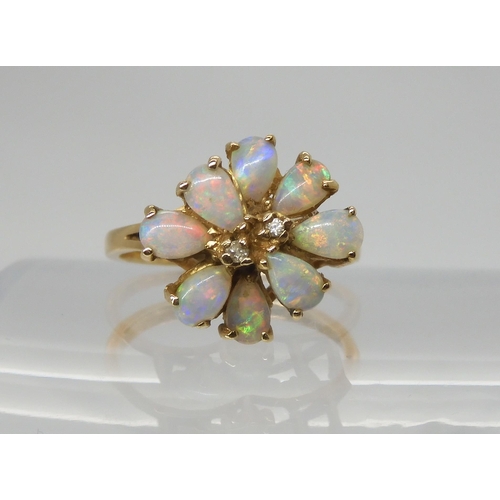 693 - A RETRO 14K GOLD OPAL CLUSTER RINGset with two diamond accents to the centre, span approx 13.4mm x 1... 