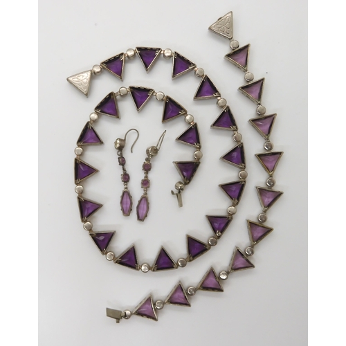 698 - A VINTAGE PURPLE GLASS SUITE OF JEWELLERYcomprising of a necklace with matching bracelet, and simila... 