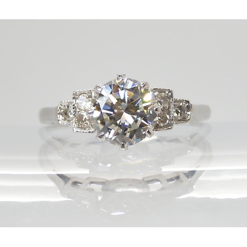 703 - A CLASSIC DIAMOND SOLITAIRE RINGset with an estimated approximately 1.05ct diamond, with further eig... 