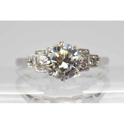 703 - A CLASSIC DIAMOND SOLITAIRE RINGset with an estimated approximately 1.05ct diamond, with further eig... 