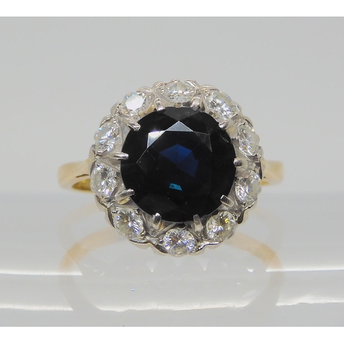 709 - AN 18CT GOLD SAPPHIRE AND DIAMOND RINGsapphire approx 9.1mm, surrounded with estimated approx 0.50ct... 