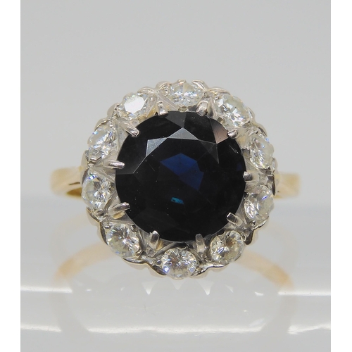 709 - AN 18CT GOLD SAPPHIRE AND DIAMOND RINGsapphire approx 9.1mm, surrounded with estimated approx 0.50ct... 