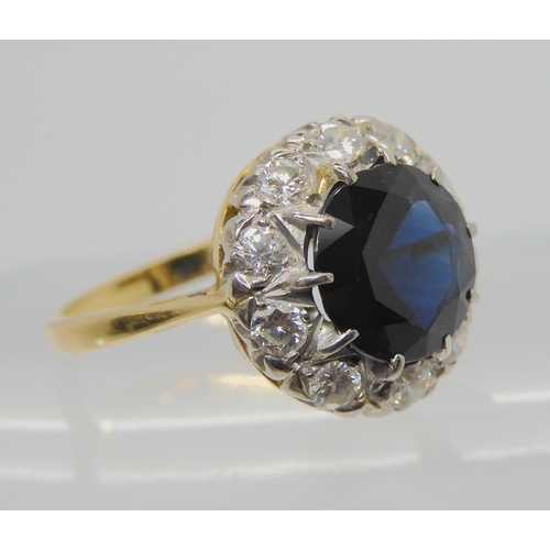 709 - AN 18CT GOLD SAPPHIRE AND DIAMOND RINGsapphire approx 9.1mm, surrounded with estimated approx 0.50ct... 