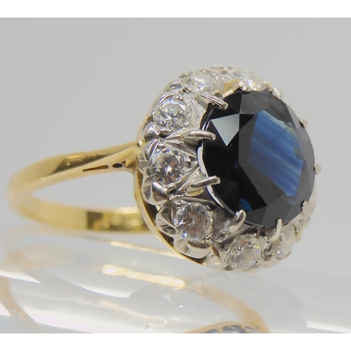 709 - AN 18CT GOLD SAPPHIRE AND DIAMOND RINGsapphire approx 9.1mm, surrounded with estimated approx 0.50ct... 