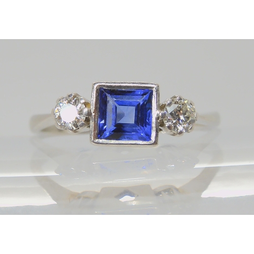 714 - A PLATINUM SAPPHIRE & DIAMOND RINGset with a square cut sapphire with the dimensions of 5mm x 5m... 