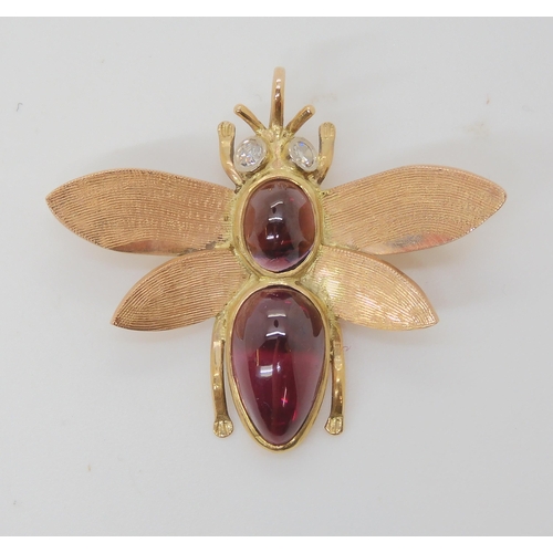 715 - A 9CT GOLD BEE BROOCHwith diamond eyes and the body set with garnets. Dimensions 3.8cm x 3.2cm, weig... 