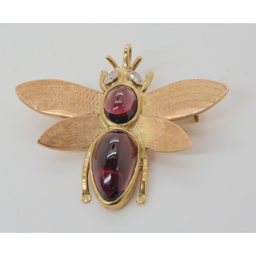 715 - A 9CT GOLD BEE BROOCHwith diamond eyes and the body set with garnets. Dimensions 3.8cm x 3.2cm, weig... 