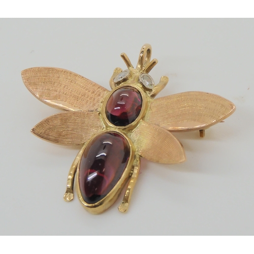 715 - A 9CT GOLD BEE BROOCHwith diamond eyes and the body set with garnets. Dimensions 3.8cm x 3.2cm, weig... 