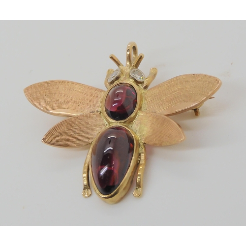 715 - A 9CT GOLD BEE BROOCHwith diamond eyes and the body set with garnets. Dimensions 3.8cm x 3.2cm, weig... 