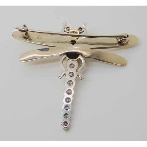 718 - A 9CT WHITE GOLD DRAGONFLY BROOCHthe tail, head and eyes are set with diamonds, to an estimated appr... 