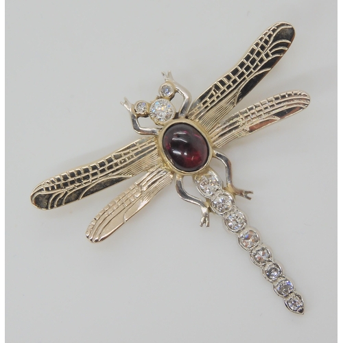 718 - A 9CT WHITE GOLD DRAGONFLY BROOCHthe tail, head and eyes are set with diamonds, to an estimated appr... 