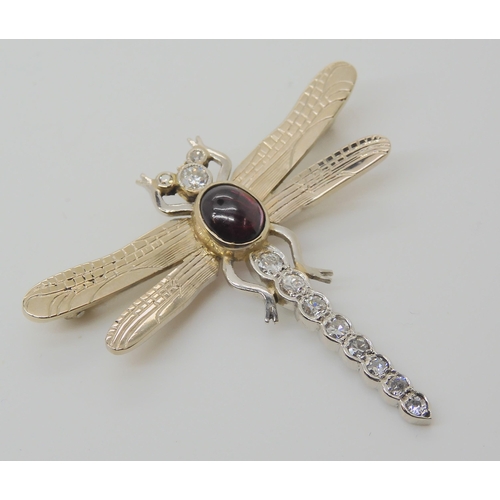 718 - A 9CT WHITE GOLD DRAGONFLY BROOCHthe tail, head and eyes are set with diamonds, to an estimated appr... 