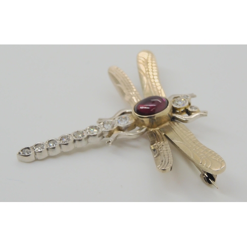 718 - A 9CT WHITE GOLD DRAGONFLY BROOCHthe tail, head and eyes are set with diamonds, to an estimated appr... 